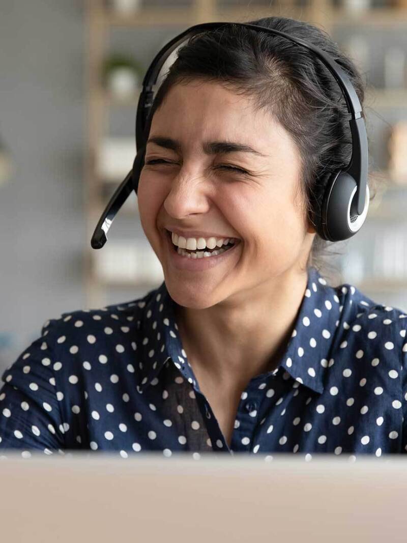 Woman with headset on laughing